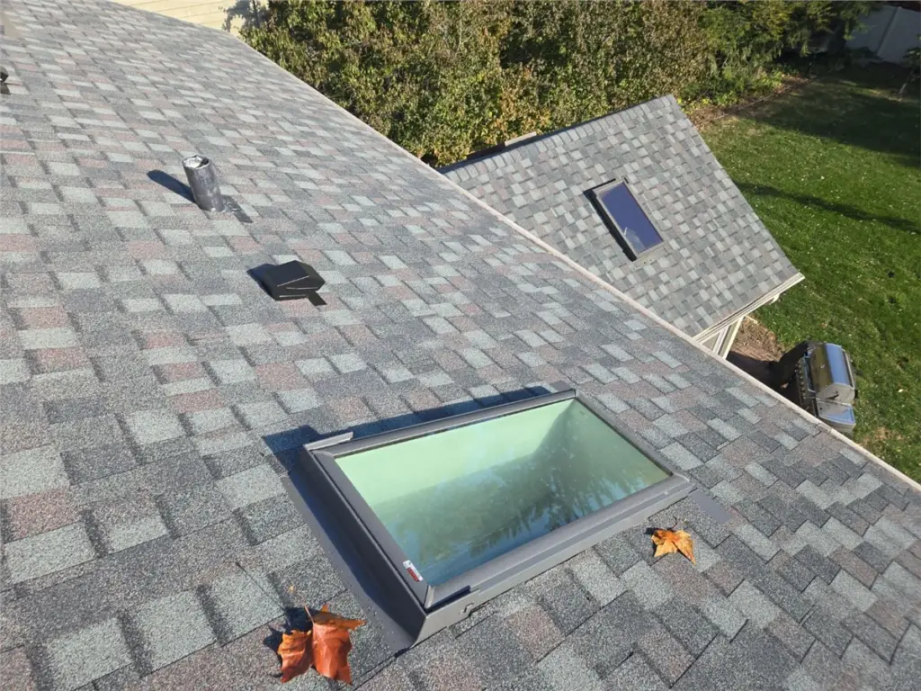 Replacement skylight installed on an asphalt shingle roof
